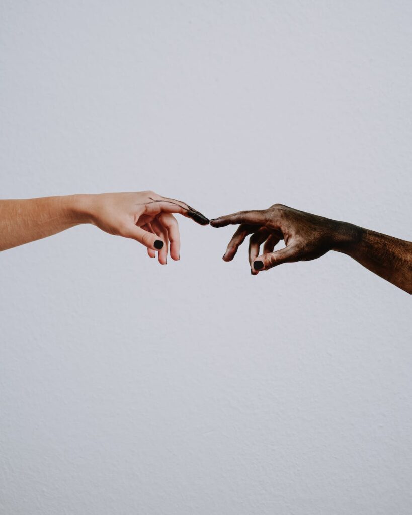 hands of people reaching to each other